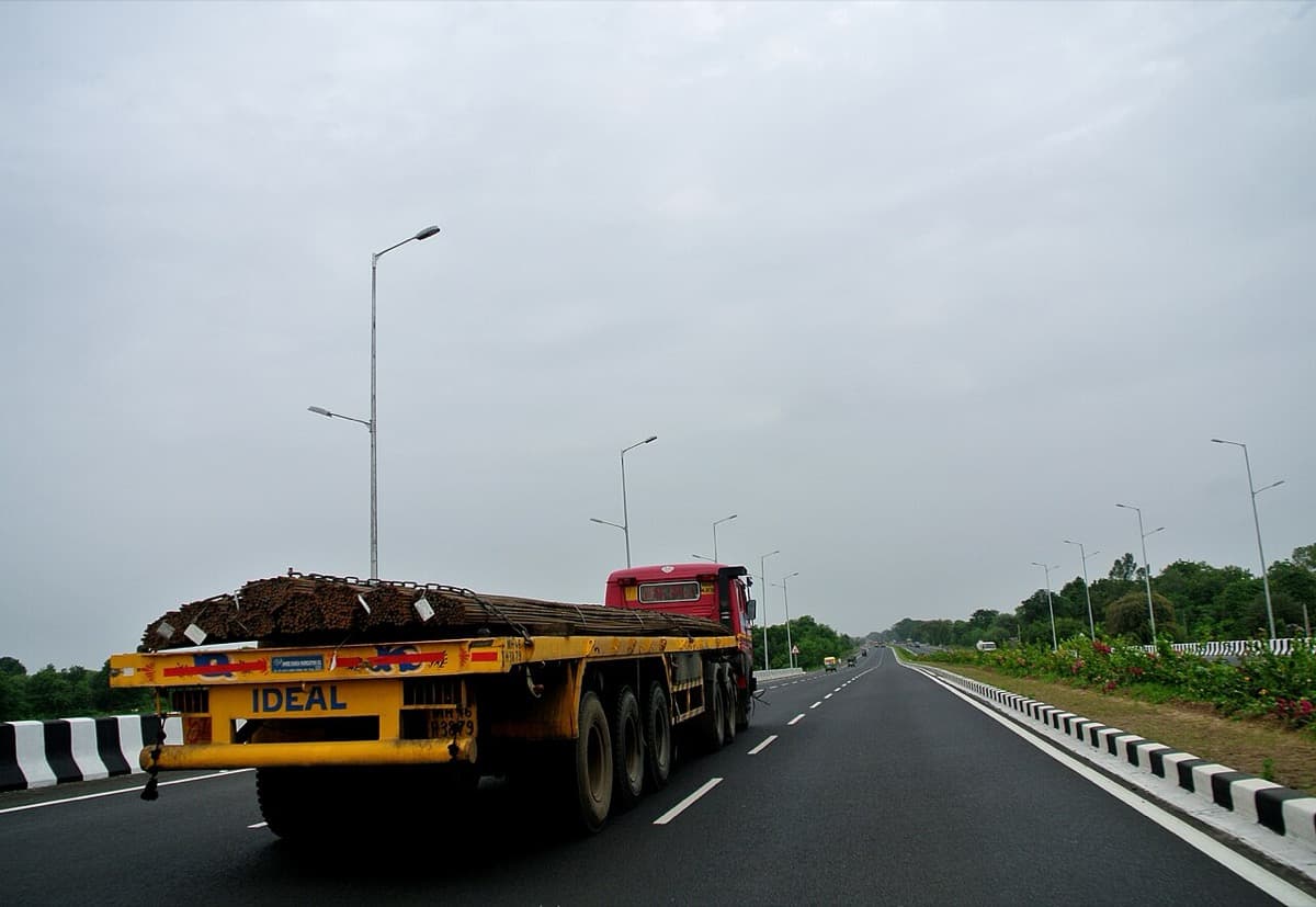 Flatbed semi-truck hauling secured building materials